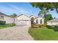Charming one-story home with a paver driveway and well-maintained landscaping at 3421 Capland Ave, Clermont, FL 34711