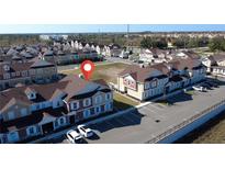 A beautiful aerial view of the resort's vibrant townhouse community with ample parking spaces available at 7562 Sunflower Cir, Kissimmee, FL 34747