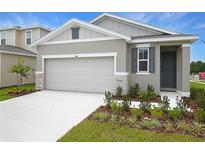 Charming single-story home with a two-car garage and well-manicured lawn at 804 Lake Dell Rd, Dundee, FL 33838