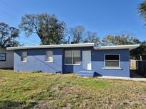 Charming, blue one story home with a simple front yard and crisp white trim details at 139 Arroyo Pkwy, Ormond Beach, FL 32174