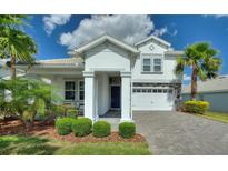 Beautiful two-story home with a well manicured lawn, stone accents, and a two car garage at 1443 Bunker Dr, Davenport, FL 33836