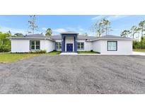 Charming single-story home with gray paint, new roof, and a well-manicured gravel yard at 19182 Seaview St, Orlando, FL 32833