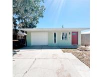 Charming single-story home featuring a red door, garage and well-maintained lawn at 3208 Timberline Road, Winter Haven, FL 33880