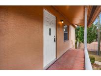 Inviting front entrance with a bright white door and a well-lit porch area at 704 Michigan Ct # 4, St Cloud, FL 34769