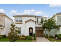 Charming two-story home featuring a well-manicured lawn, stone accents, and a cozy front porch at 8943 Amelia Downs Trl, Kissimmee, FL 34747
