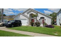 Beautifully landscaped front yard adds to the curb appeal of this lovely home at 1019 Lake Berkley Dr, Kissimmee, FL 34746