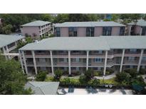 Aerial view of a three-story condo complex with a swimming pool and lounge chairs at 131 Water Front Way # 220, Altamonte Springs, FL 32701