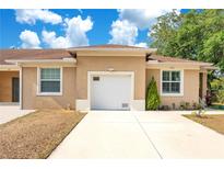 Inviting home exterior featuring a one car garage, well kept lawn, and natural light at 1773 Barton Towne Cir, St Cloud, FL 34769