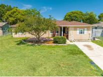 Charming single-story home featuring a well-manicured lawn and mature shade tree in a desirable neighborhood at 2430 Mill Run Blvd, Kissimmee, FL 34744