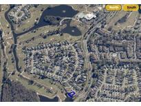 Community aerial view featuring golf course, lake, and nearby amenities at 2615 Autumn Green Dr, Orlando, FL 32822