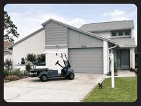 Charming single-Gathering home featuring a well-maintained lawn and a convenient attached garage at 2615 Autumn Green Dr, Orlando, FL 32822