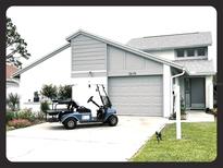 Charming single-Gathering home showcasing a well-maintained front yard and a two-car garage at 2615 Autumn Green Dr, Orlando, FL 32822