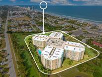 Expansive aerial view of beachfront condo building near Daytona Beach, Florida with ocean views at 4 Oceans West Blvd # 301B, Daytona Beach Shores, FL 32118