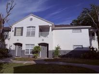 Charming two-story condo with gray doors and a cozy balcony on a sunny day at 4328 S Kirkman Rd # 1, Orlando, FL 32811