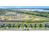 New construction community with stunning aerial views of homes, landscaping, and surrounding lakes at 452 Burnham Cir, Auburndale, FL 33823