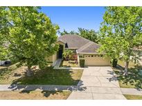 Charming single-story home with a well-manicured lawn and mature trees in a desirable neighborhood at 5365 Dahlia Reserve Dr, Kissimmee, FL 34758