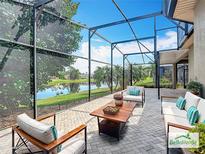 Enjoy a luxurious outdoor living space with screened patio overlooking the serene lake view at 567 Villa Park Rd, Kissimmee, FL 34759