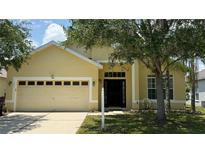 Charming single-Gathering home with a two-car garage and well-manicured lawn, offering classic curb appeal at 954 Hacienda Cir, Kissimmee, FL 34741