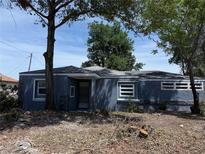 Cozy single-story home with blue siding, stone accents, and mature trees at 115 N 10Th St, Haines City, FL 33844