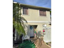 Charming home with a front yard decorated with Easter-themed decor and palm trees at 135 Pine Island Cir, Kissimmee, FL 34743