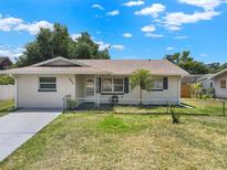 Charming single story home featuring a well-maintained lawn, fresh paint, and a decorative front door at 2317 10Th St, St Cloud, FL 34769