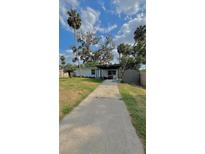 Charming single-story home with a covered front porch and mature landscaping under a bright blue sky at 2350 Valley Dr, Apopka, FL 32703