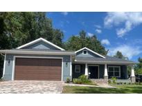 Charming single-story home with a two-car garage and a covered porch at 2943 Annalee Rd, St Cloud, FL 34771