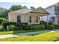 Charming single-story home featuring a quaint front porch, well-maintained landscaping, and a welcoming facade at 6821 Cultivation Way, Winter Garden, FL 34787