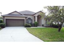 Charming single-story home with a two-car garage and well-manicured lawn at 925 Montana Ave, Davenport, FL 33897