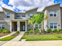 Modern townhouse featuring a landscaped front yard and a contemporary architectural design at 1058 Splash Shot Pl, Davenport, FL 33896