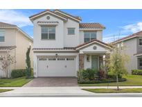 Beautiful two-story home with tile roof, well-maintained lawn, two-car garage and neutral exterior at 13282 Bromborough Dr, Orlando, FL 32832