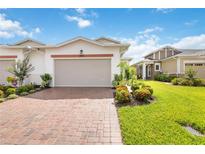 Charming villa featuring a red brick driveway and lush landscaping at 2503 Yellow Brick Rd, St Cloud, FL 34772