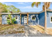 Charming blue single-story home with mature landscaping and inviting front entrance at 407 S Lakemont Ave, Winter Park, FL 32792