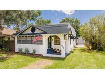Charming vintage bungalow with American flag, front porch, and landscaped yard at 415 Florida Ave, St Cloud, FL 34769