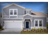 Charming two-story home with a well-manicured lawn and attached two-car garage at 4473 Kaipo Rd, Davenport, FL 33897
