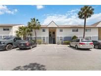 Condo exterior featuring well-maintained landscaping and ample parking at 4722 Kilt Ct # 65, St Cloud, FL 34769