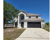 Charming two-story home with a two car garage and a well-manicured lawn at 511 Elbridge Pl, Kissimmee, FL 34758