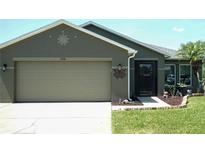 Charming single-story home features a neutral color scheme, two car garage and manicured lawn at 2206 Hunters Greene Dr, Lakeland, FL 33810