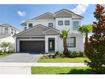 Beautiful two-story home featuring a modern design, a well-maintained yard, and a two-car garage at 2649 Calistoga Ave, Kissimmee, FL 34741