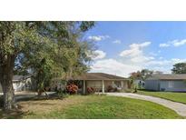 Charming single-story home with a well-maintained lawn and a driveway at 2947 Larson St, Kissimmee, FL 34741