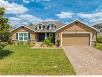 Charming single-story home featuring a well-manicured lawn, beautiful landscaping, and an inviting front entrance at 3101 Drema Dr, St Cloud, FL 34769