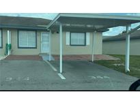 Cozy single-story home featuring a covered carport and neatly paved front entrance at 344 Winter Ridge Blvd # 344, Winter Haven, FL 33881