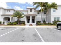 Charming townhome featuring manicured landscaping, covered entries, and convenient parking spaces at 4835 Memories Ln, Kissimmee, FL 34746