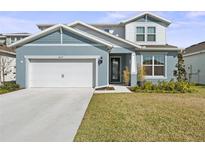 Charming two-story home with a well-manicured lawn, a two car garage and a welcoming front entrance at 6019 Forest Perch Dr, St Cloud, FL 34771