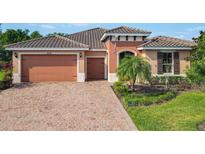 Charming single-story home featuring a brick driveway, two-car garage, and tile roof at 819 San Raphael St, Kissimmee, FL 34759