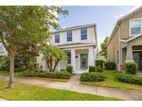 Charming two-story home with a well-manicured lawn and a welcoming front porch at 11843 Fiction Ave, Orlando, FL 32832