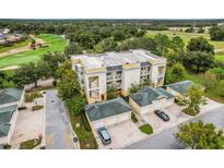 A beautiful condo complex featuring multiple units with garages, and verdant green surroundings at 1501 Northern Harrier Way # 101, Kissimmee, FL 34747