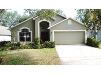 Charming single-Gathering home with a well-manicured lawn and a two-car garage at 2365 Paulette Dr, Haines City, FL 33844