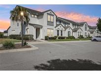 Charming townhome with modern architecture, lush landscaping, and convenient parking at 256 Captiva Dr, Davenport, FL 33896