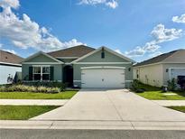 Charming single-story home with a well-manicured lawn and a two-car garage at 4373 Deleon St, Haines City, FL 33844